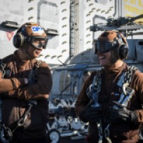 PACIFIC OCEAN (Dec. 3, 2016) Seaman George Sablan, left, and Seaman Abraham Alvarez, both assigned to the Gray Wolves of Electronic Attack Squadron (VAQ) 142 stand on the flight deck of the aircraft carrier USS Nimitz (CVN 68). Nimitz is currently underway conducting Tailored Ship's Training Availability and Final Evaluation Problem (TSTA/FEP), which evaluates the crew on their performance during training drills and real-world scenarios. Once Nimitz completes TSTA/FEP they will begin Board of Inspection and Survey (INSURV) and Composite Training Unit Exercise (COMPTUEX) in preparation for an upcoming 2017 deployment. (U.S. Navy photo by Petty Officer 2nd Class Siobhana R. McEwen/Released)